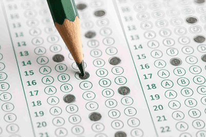Pencil filling in bubbles on a multiple-choice answer sheet