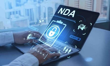 Person at a laptop with a Non-Disclosure Agreement and lock icon on the screen